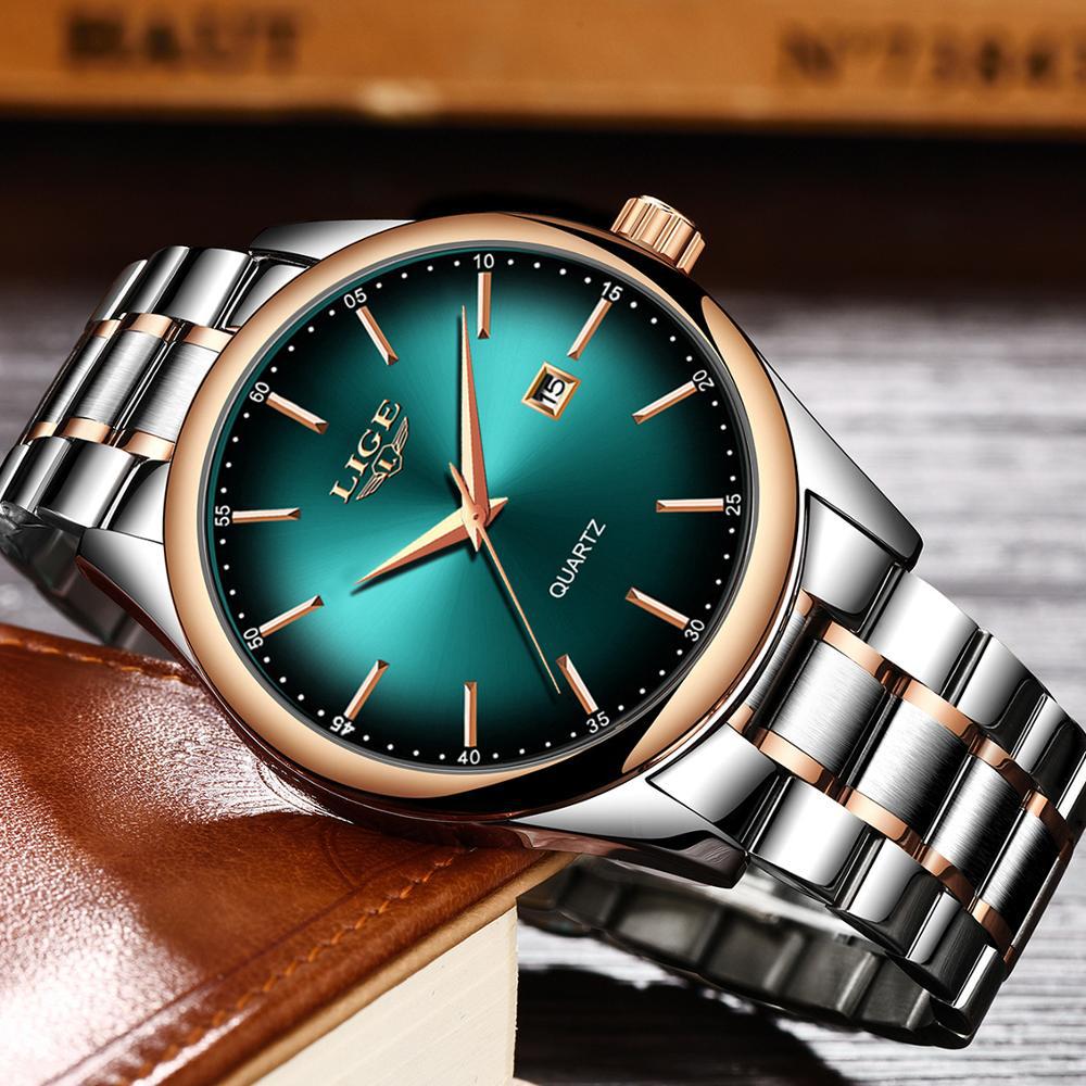 Green dial LIGE watch on a steel bracelet resting against a leather notebook